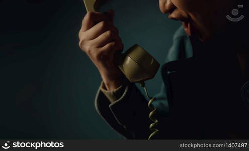 Angry Person Shouting to the Retro Telephone. Cropped image, Vintage Colour Tone