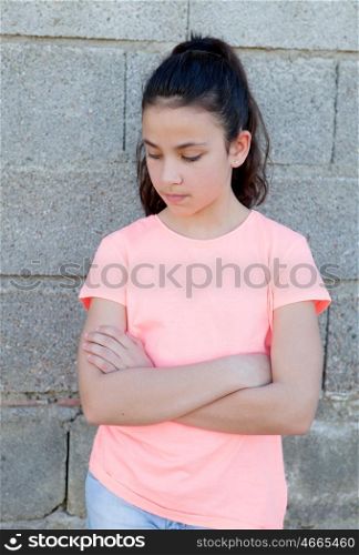Angry preteen girl with pink t-shirt in the street