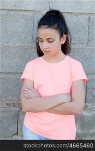 Angry preteen girl with pink t-shirt in the street