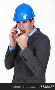 angry real estate businessman shouting on his cell phone