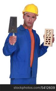 Angry tradesman holding a brick and trowel