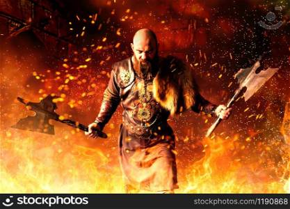 Angry viking with axes in hands dressed in traditional nordic clothes standing in fire. Scandinavian ancient warrior