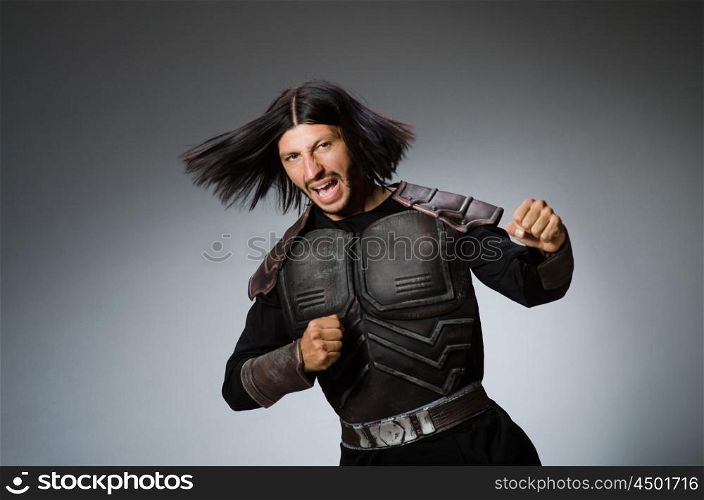 Angry warrior against dark background