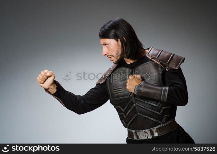 Angry warrior against dark background