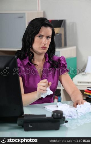 Angry woman crumpling papers