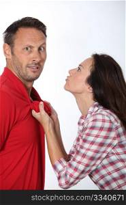 Angry woman pulling boyfriend shirt neck