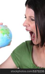 Angry woman with a globe