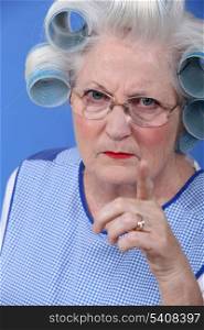 Angry woman with her hair in rollers