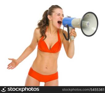 Angry young woman in swimsuit shouting through megaphone