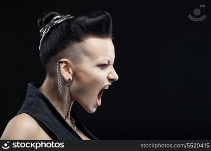 angry young woman screaming isolated on black background with copyspace