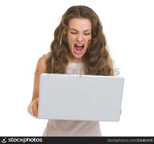 Angry young woman yelling on laptop
