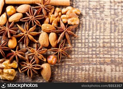 anise, nuts and cinnamon on wooden table
