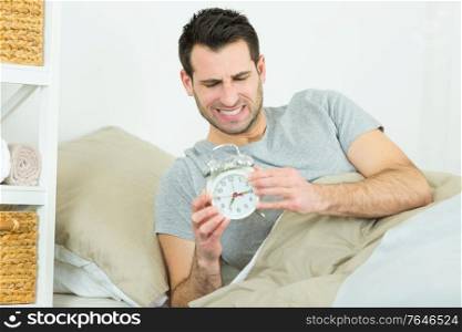 annoyed man with the alarm clock