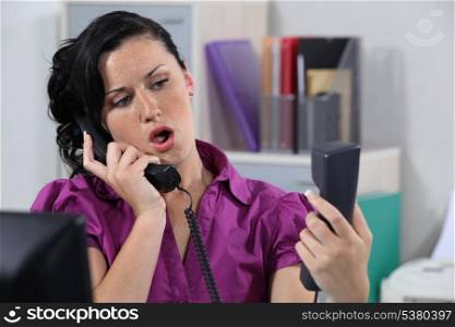 Annoyed receptionist answering ringing phones
