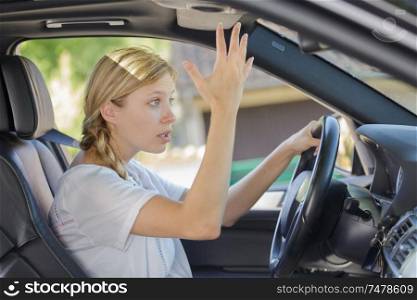 annoyed woman driving a car