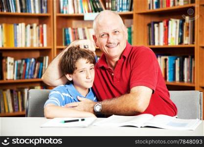 Annoying father teasing his son when they are supposed to be studying at the library.