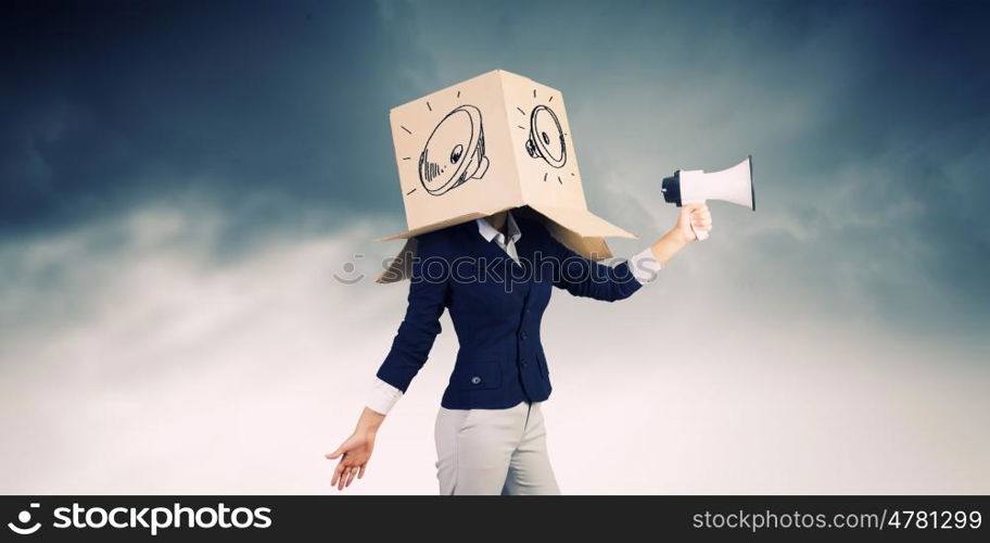 Anonymous announcement. Businesswoman wearing carton box on head and speaking in megaphone