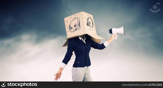 Anonymous announcement. Businesswoman wearing carton box on head and speaking in megaphone