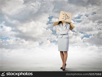 Anonymous announcement. Businesswoman wearing carton box with sign on head