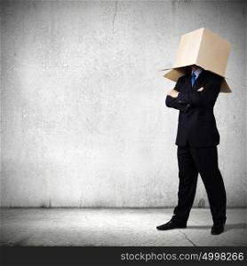 Anonymous businessman. Businessman in suit wearing carton box on head
