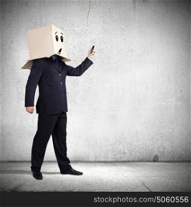 Anonymous call. Businessman using mobile phone wearing carton box on head