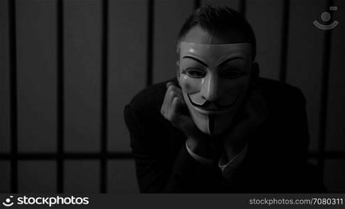 Anonymous hacker glares at camera in prison (B/W Version)