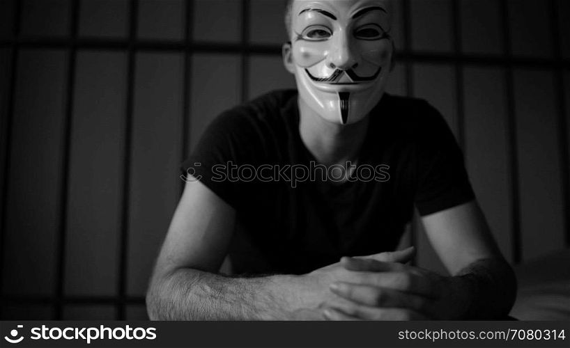 Anonymous hacker in prison glares at camera (B/W Version)