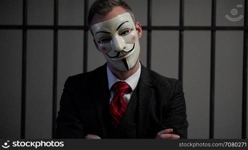 Anonymous hacker in prison has head tilted with attitude