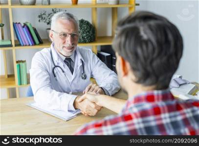 anonymous patient shaking hand doctor