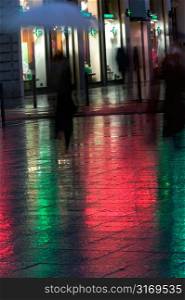 Anonymous Pedestrians Walking In The Rain