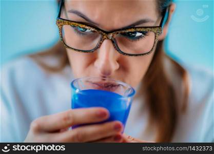 Anosmia or smell blindness, loss of the ability to smell, one of the possible symptoms of covid-19, infectious disease caused by corona virus. Woman Trying to Sense Smell of a Candle . Anosmia or smell blindness