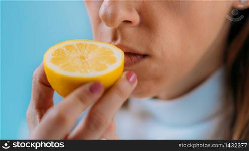Anosmia or smell blindness, loss of the ability to smell, one of the possible symptoms of covid-19, infectious disease caused by corona virus. Woman Trying to Sense Smell of a Lemon. Anosmia or smell blindness