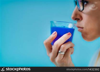 Anosmia or smell blindness, loss of the ability to smell, one of the possible symptoms of covid-19, infectious disease caused by corona virus. Woman Trying to Sense Smell of a Candle . Anosmia or smell blindness, loss of the ability to smell