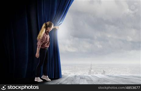 Another reality. Young woman in casual opening blue curtain