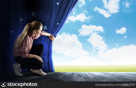 Another reality. Young woman in casual opening blue curtain