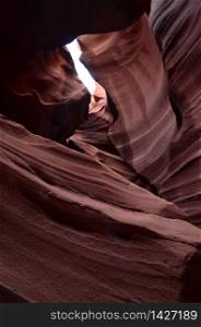 Antelope canyon with winding red rocks with patterns.