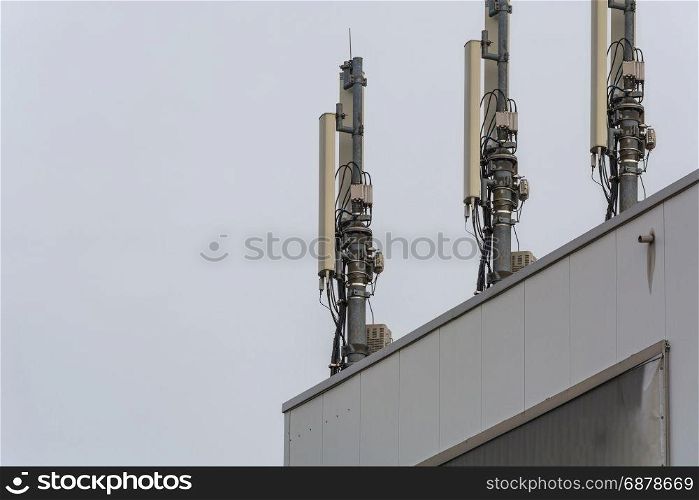 Antenna, telecommunications tower on a roof, wireless telecommunications concept.