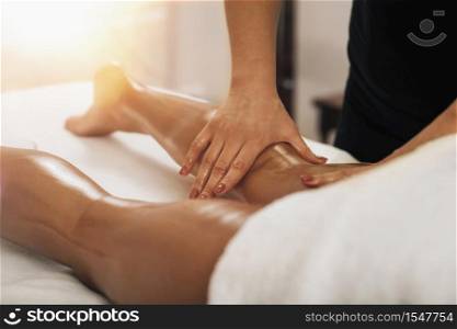 Anti cellulite massage. Masseuse massaging a calf area of a female leg to reduce cellulite . Anti Cellulite Massage. Masseuse Massaging a Female Calf
