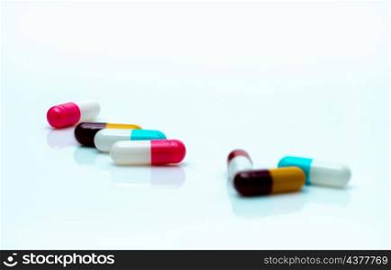 Antibiotic capsule pills on white background. Prescription drugs. Colorful capsule pills. Antibiotic drug resistance concept. Pharmaceutical industry. Superbug problems. Medicament and pharmacology.