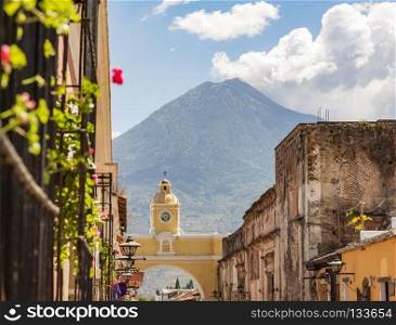 Antigua Guatemala, classic colonial town with famous Arco de Santa Catalina and Volcan de Agua behind