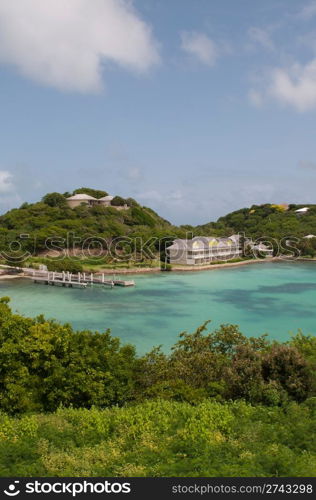 Antigua Long Bay, gorgeous seascape view surrounded by tropical nature and some typical houses