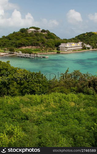 Antigua Long Bay, gorgeous seascape view surrounded by tropical nature and some typical houses