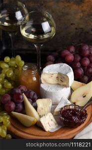 Antipasti. Cheese camembert with grapes, sliced pears and confiture, a great appetizer for wine.