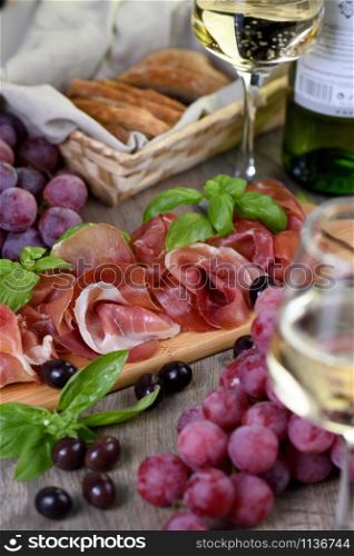 Antipasto. Wine set snack sun-dried ham jamon with grapes and olives