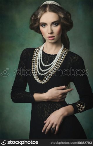 antique aristocratic lady with elegant dress, precious jewellery, brilliant crown and medieval hair-style. Fantasy fashion shoot