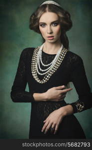 antique aristocratic lady with elegant dress, precious jewellery, brilliant crown and medieval hair-style. Fantasy fashion shoot