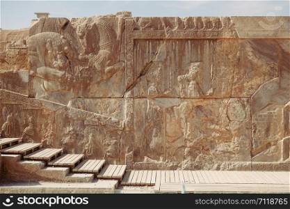 Antique bas-relief and ancient Cuneiform inscription at the Persepolis. Marvdasht, Fars Province, Iran.
