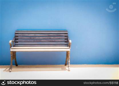 Antique bench on blue concrete background