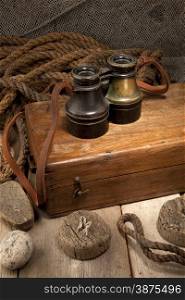 Antique binoculars on old wooden box