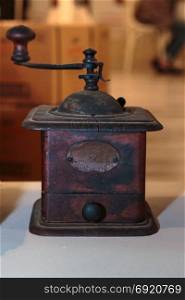 Antique Black Coffee Grinder on White Table